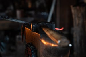 Hammer resting on an anvil.